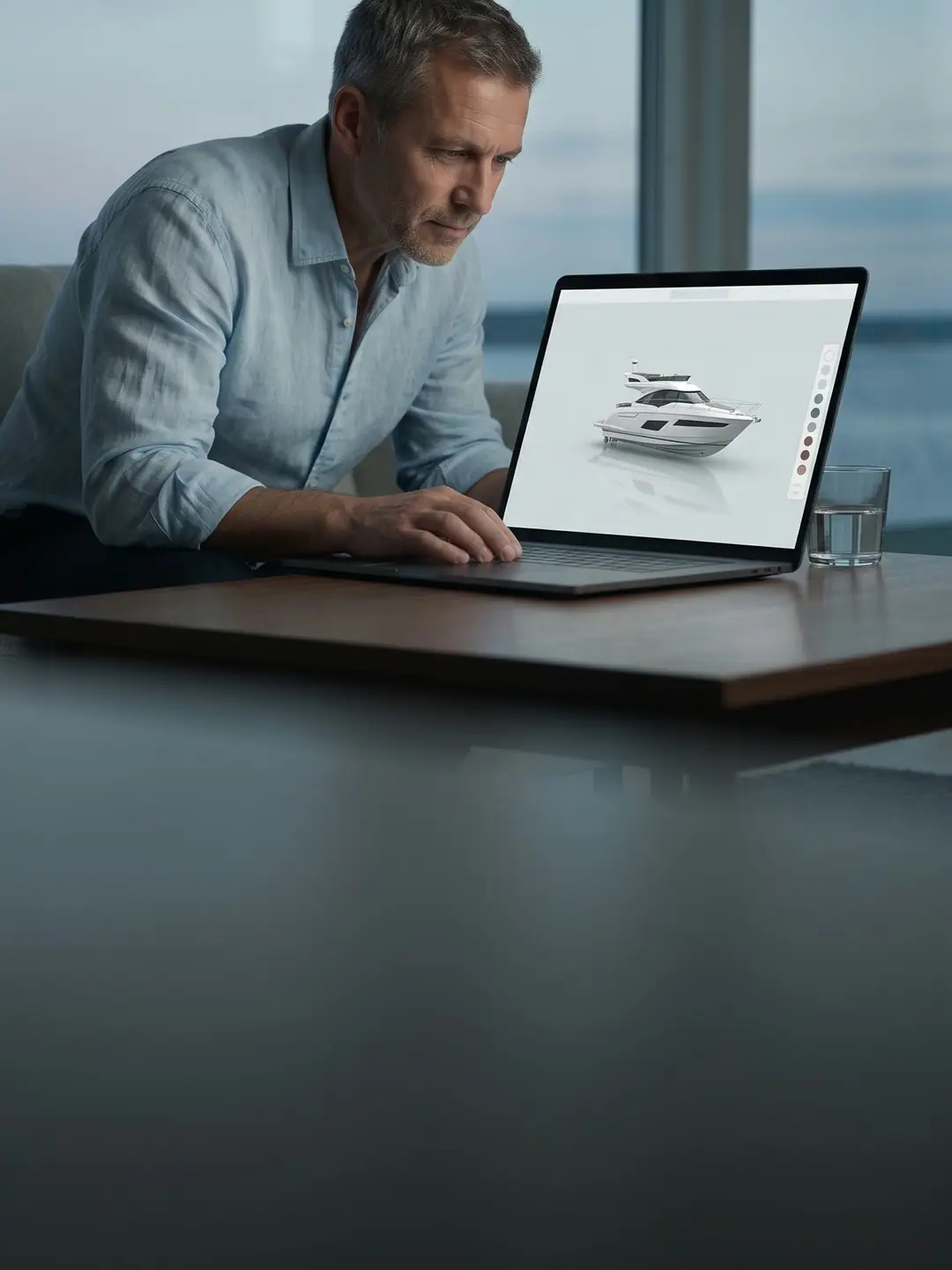 A customer choosing boat options on a laptop at home.