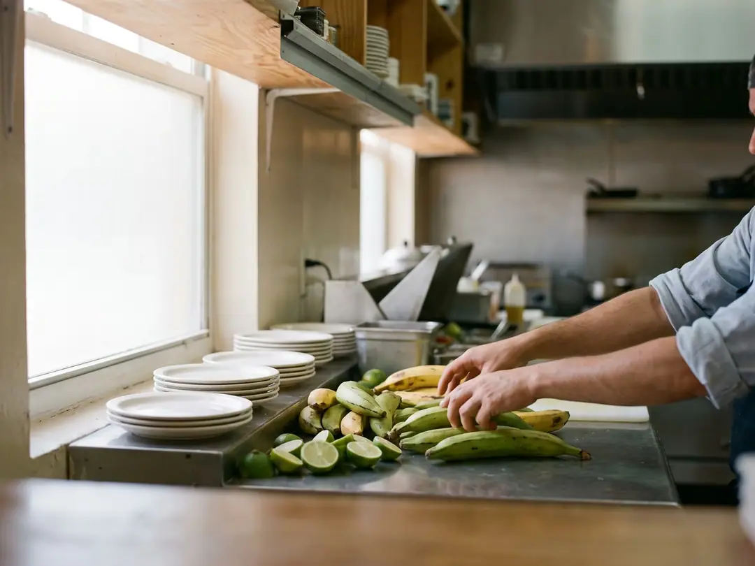A restaurant kitchen pass with fresh produce and plates ready for service.